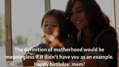 Mother and daughter smiling with a birthday candle